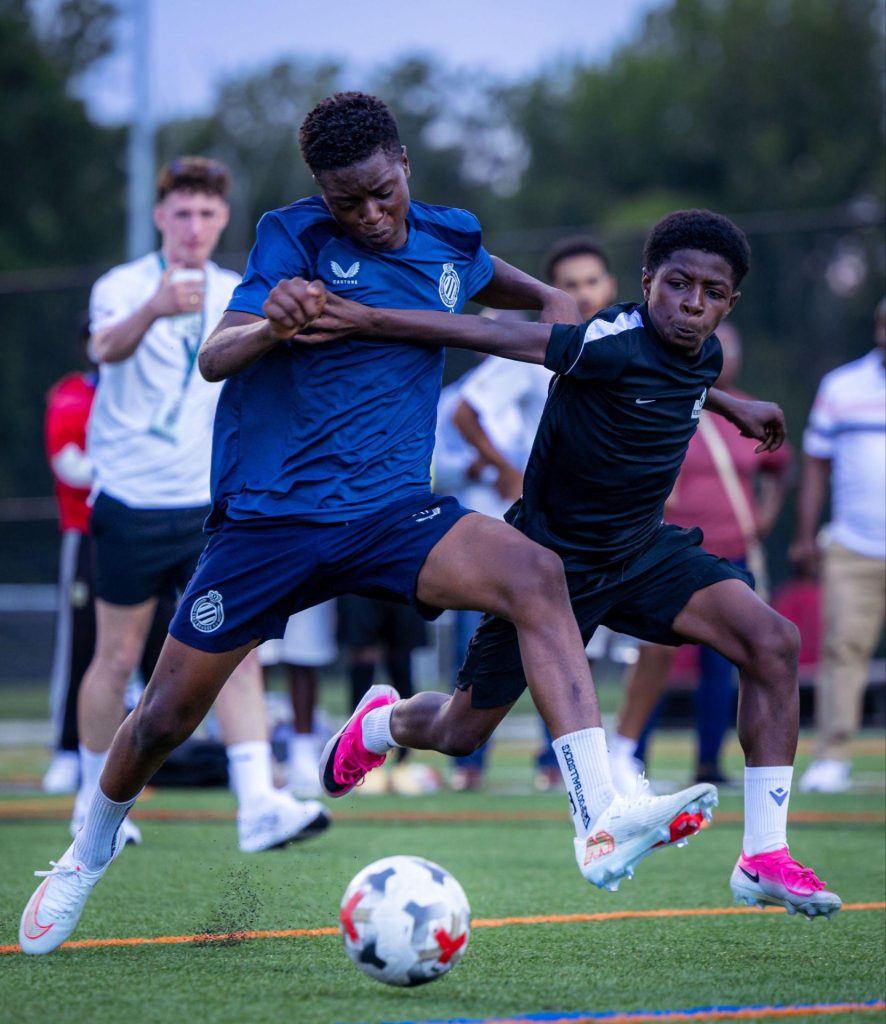 Two young TSF players competing for the ball during a match