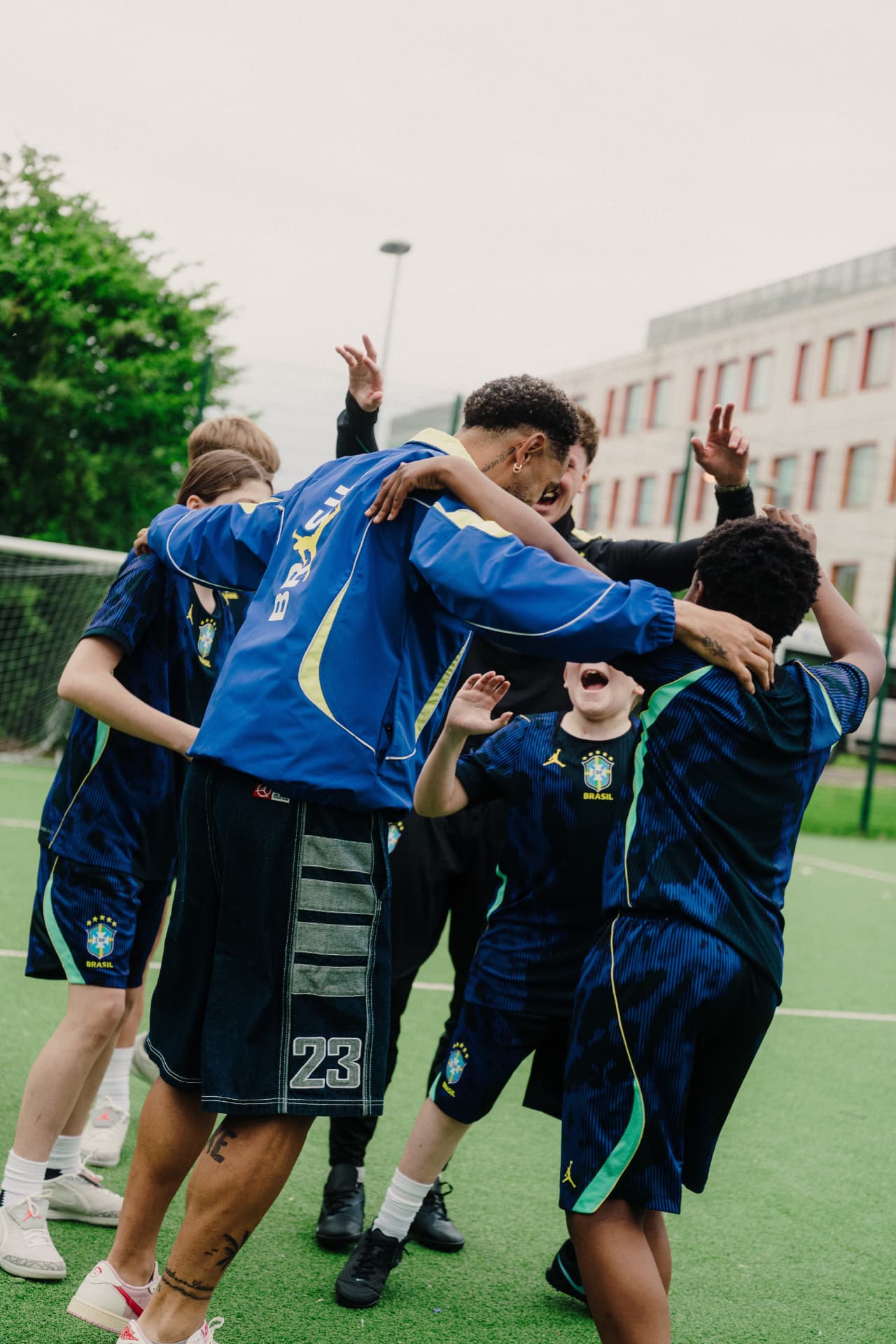 Young players and coaches celebrating together in a huddle